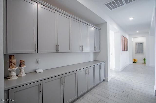 kitchen with light hardwood / wood-style floors and gray cabinetry