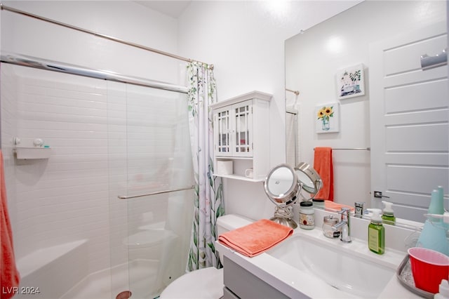 bathroom featuring walk in shower, vanity, and toilet