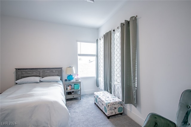 bedroom featuring light colored carpet