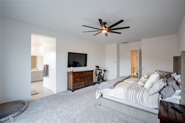 carpeted bedroom featuring ensuite bath and ceiling fan