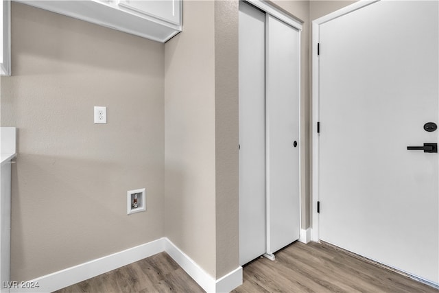 laundry room with washer hookup and light hardwood / wood-style floors