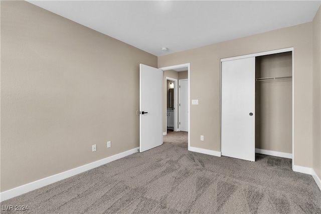 unfurnished bedroom featuring carpet floors and a closet