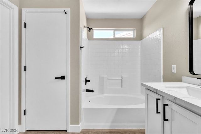 bathroom featuring vanity, bathing tub / shower combination, and hardwood / wood-style flooring