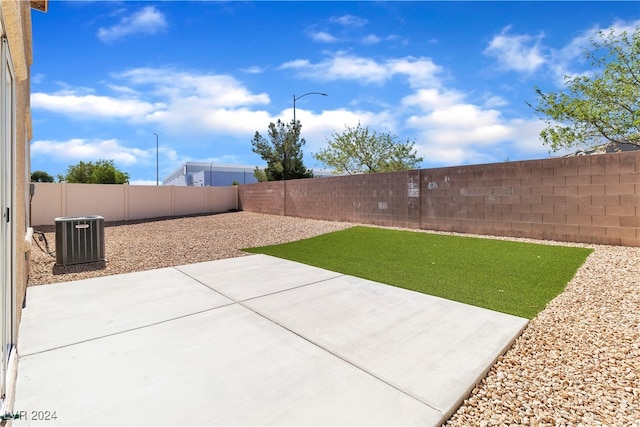 view of yard with a patio and central air condition unit