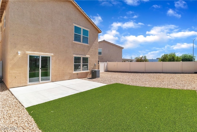 back of property with a patio area and a yard