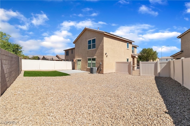 rear view of house with a patio and central air condition unit