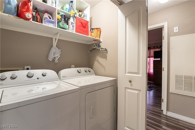 laundry area featuring washer and clothes dryer and dark wood-type flooring