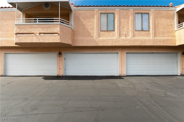 view of front of house with a balcony and a garage