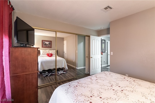 bedroom featuring a closet and dark hardwood / wood-style floors