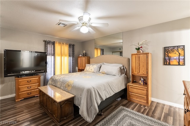 bedroom with ceiling fan and dark hardwood / wood-style flooring