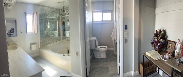 full bathroom featuring a notable chandelier, separate shower and tub, vanity, and toilet