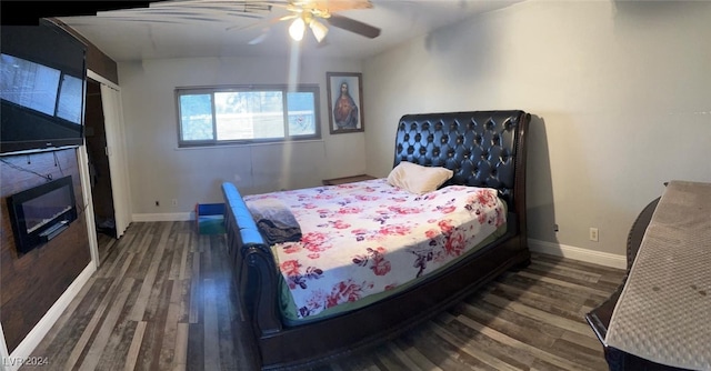 bedroom with ceiling fan and dark wood-type flooring