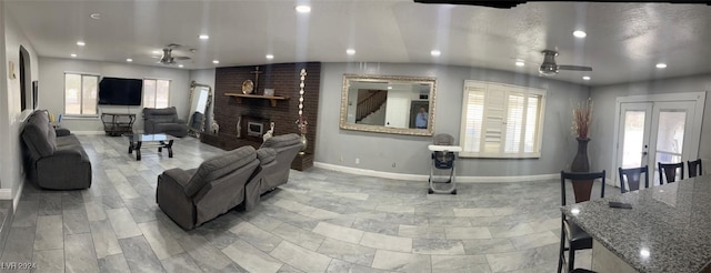 living room with a healthy amount of sunlight, ceiling fan, and french doors