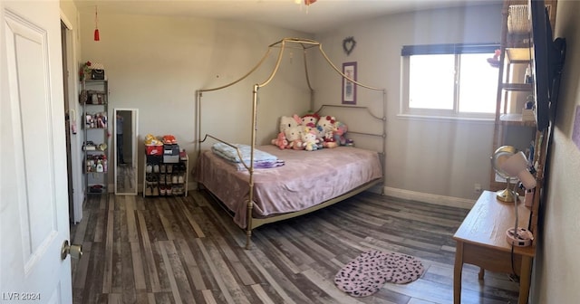 bedroom with dark hardwood / wood-style floors