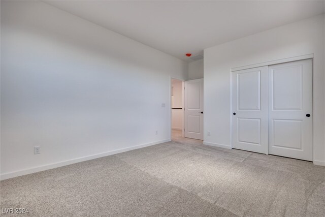 unfurnished bedroom with carpet and a closet