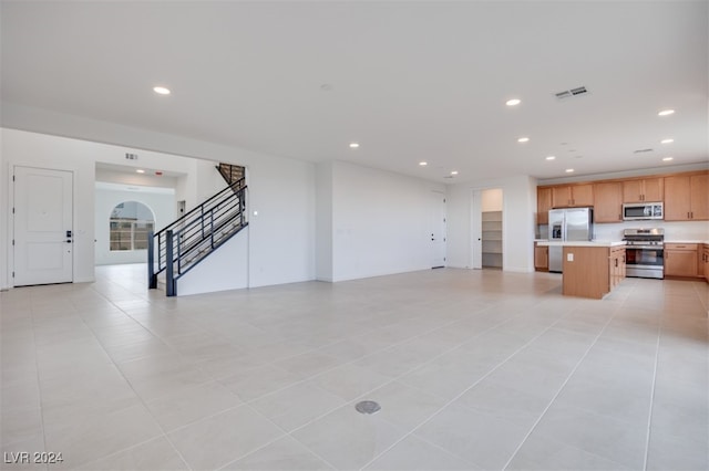 unfurnished living room featuring light tile patterned flooring