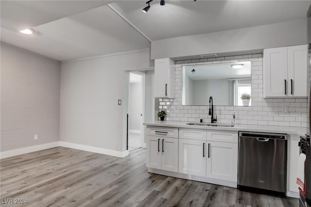 kitchen with white cabinetry, stainless steel dishwasher, sink, light wood-type flooring, and backsplash