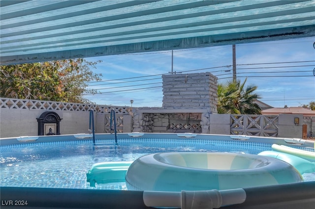 view of pool with a hot tub