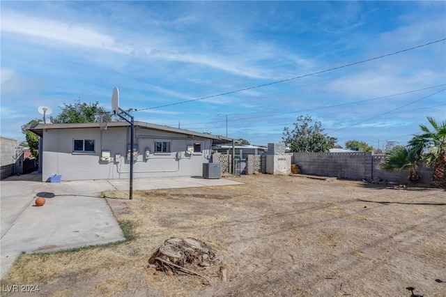 back of property with a patio area and central AC unit