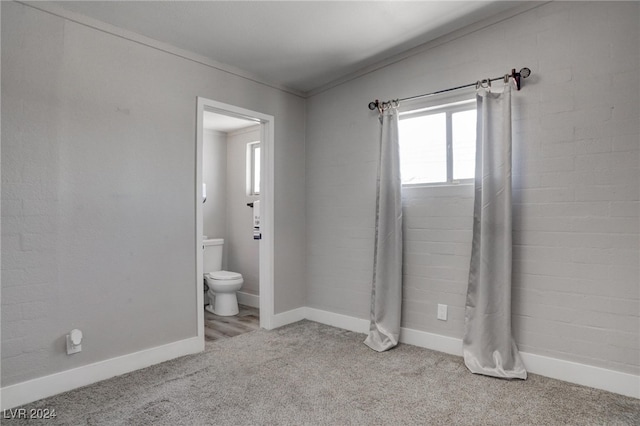 bathroom with toilet and ornamental molding