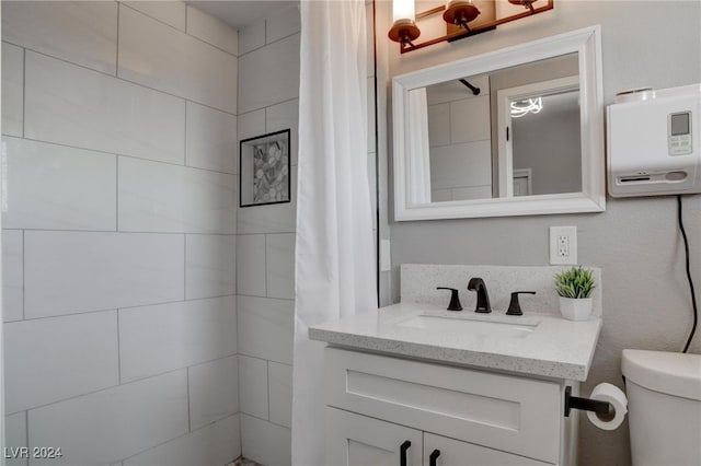 bathroom with vanity, toilet, and a shower with shower curtain