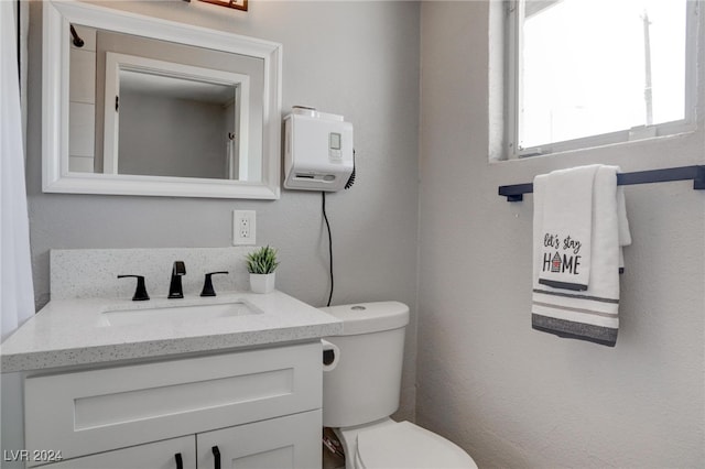 bathroom featuring toilet and vanity