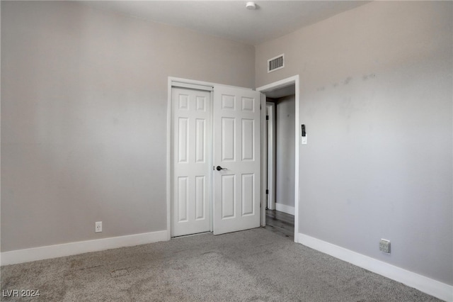 unfurnished bedroom featuring a closet and carpet flooring