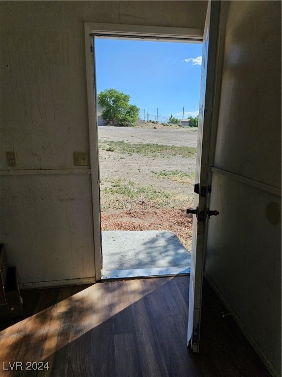 doorway to outside featuring dark wood-type flooring