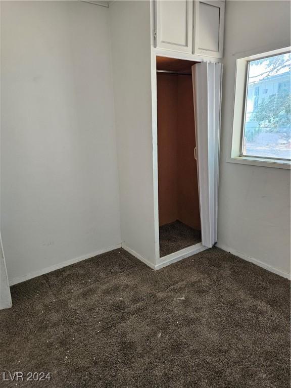 310 Arizona St, Tonopah, NV 89049 - unfurnished bedroom featuring carpet, baseboards, and a closet