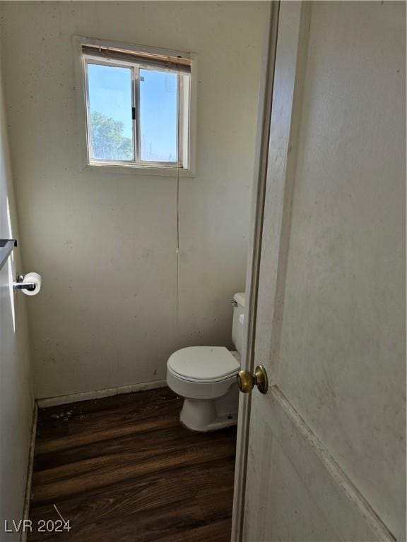 bathroom featuring wood finished floors and toilet