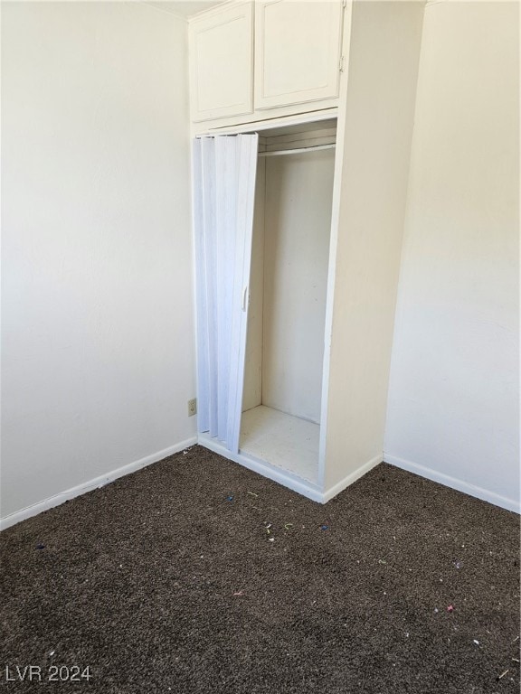 unfurnished bedroom featuring carpet floors and a closet