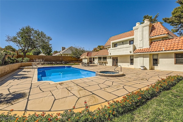 view of pool with an in ground hot tub and a patio area