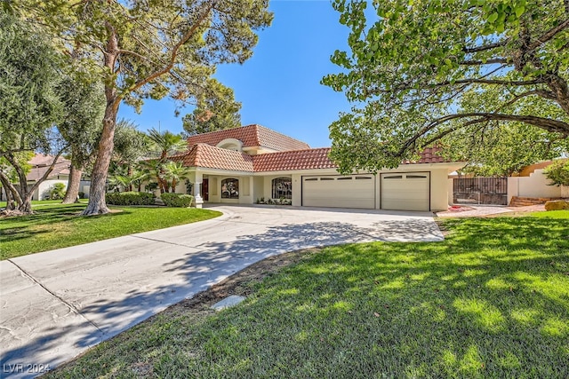 view of front of property featuring a garage and a front lawn