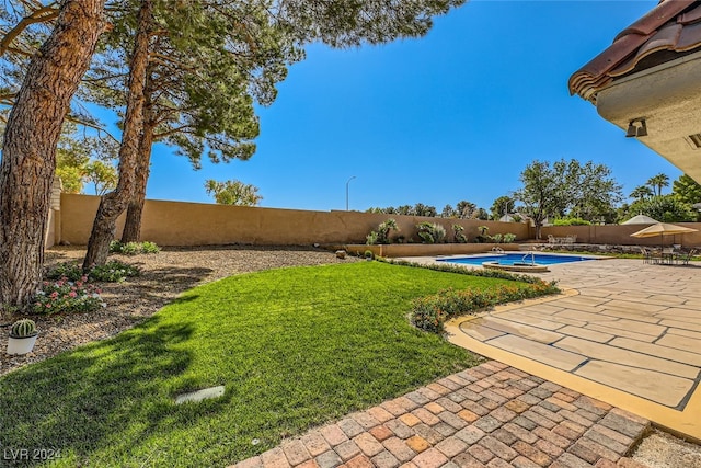 view of yard featuring a patio and a fenced in pool