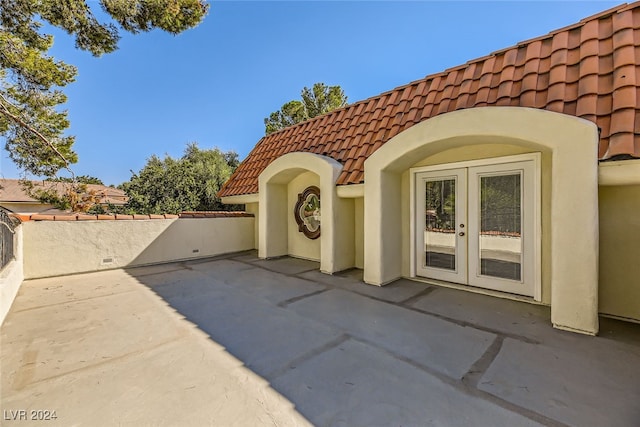 entrance to property featuring a patio and french doors