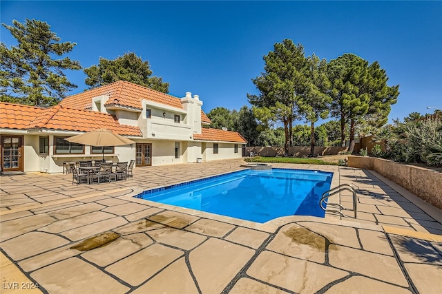 view of swimming pool featuring a patio area