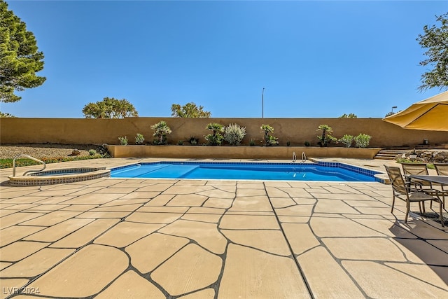 view of pool featuring an in ground hot tub and a patio area