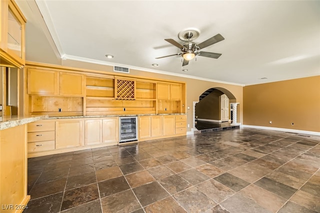 kitchen featuring light brown cabinetry, beverage cooler, ornamental molding, and ceiling fan