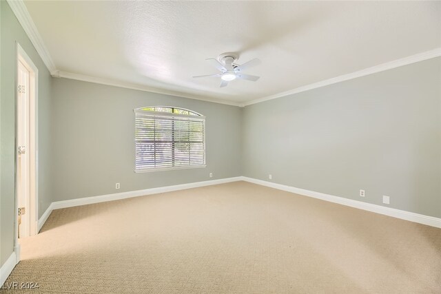 unfurnished room with carpet floors, ornamental molding, and ceiling fan