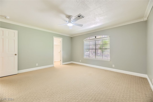 carpeted empty room featuring ceiling fan and ornamental molding