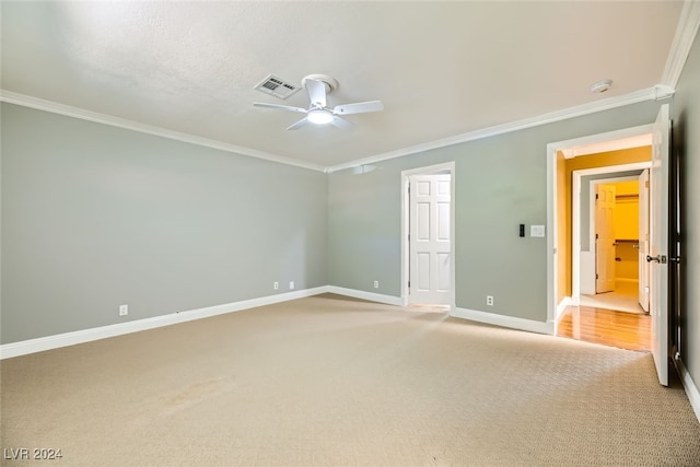 unfurnished bedroom featuring crown molding, carpet, and ceiling fan