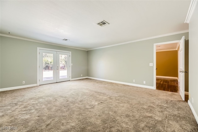 empty room featuring french doors, ornamental molding, and carpet