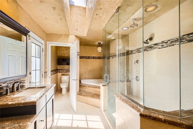 full bathroom featuring tile patterned floors, independent shower and bath, vanity, and toilet