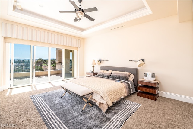 bedroom featuring access to exterior, carpet flooring, a tray ceiling, and ceiling fan