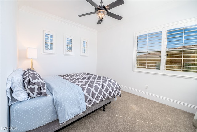 bedroom with carpet, ceiling fan, and crown molding