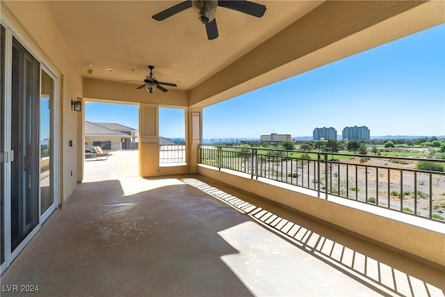 view of patio / terrace with a balcony and ceiling fan