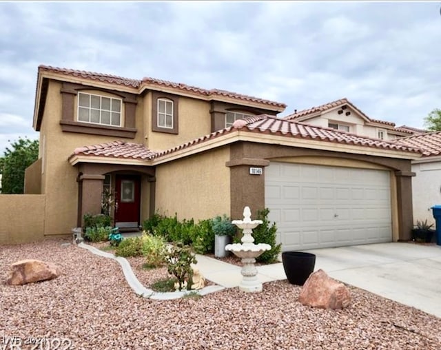 mediterranean / spanish-style home with a garage