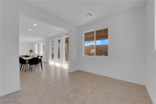 tiled empty room featuring a healthy amount of sunlight