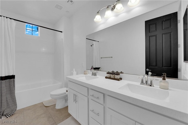 bathroom featuring shower / bathtub combination with curtain, a sink, toilet, and tile patterned floors