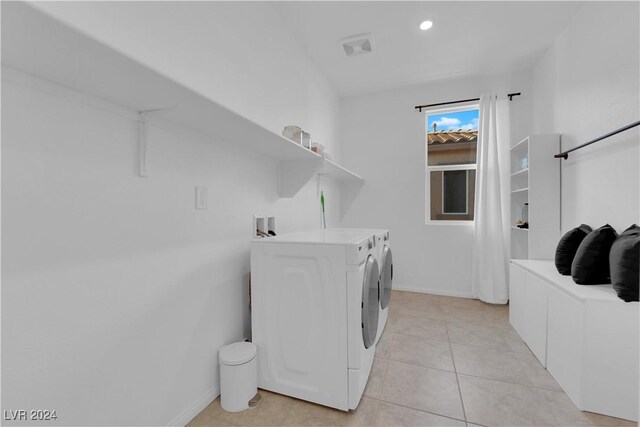 laundry area featuring independent washer and dryer and light tile patterned flooring